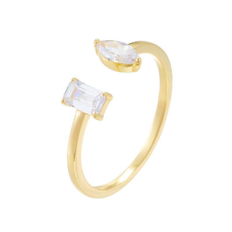 Gold ring with two clear gemstones on a white background