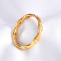 Gold ring with diamond accents on a white background